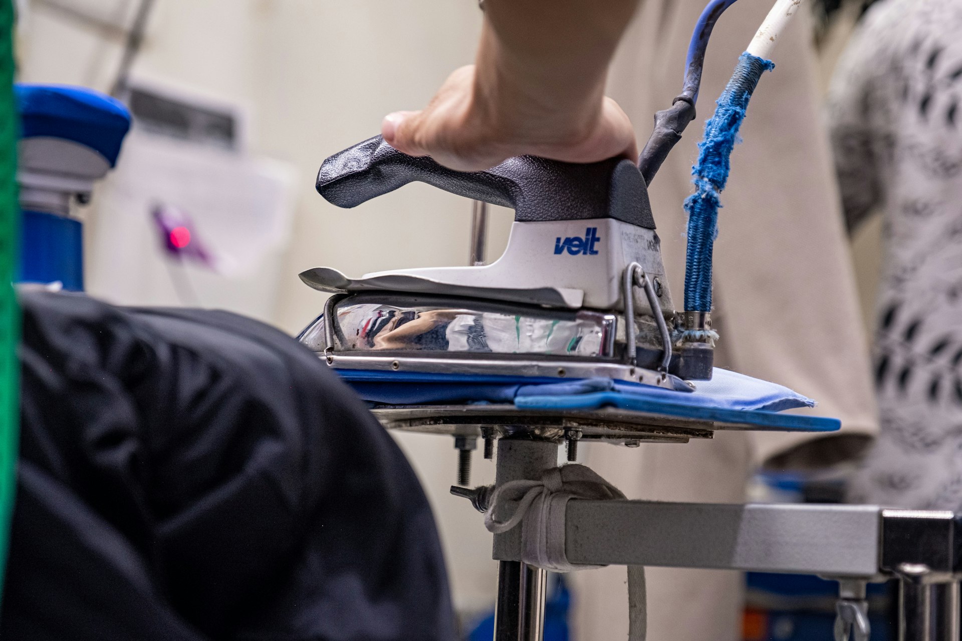 a close up of a person ironing a shirt
